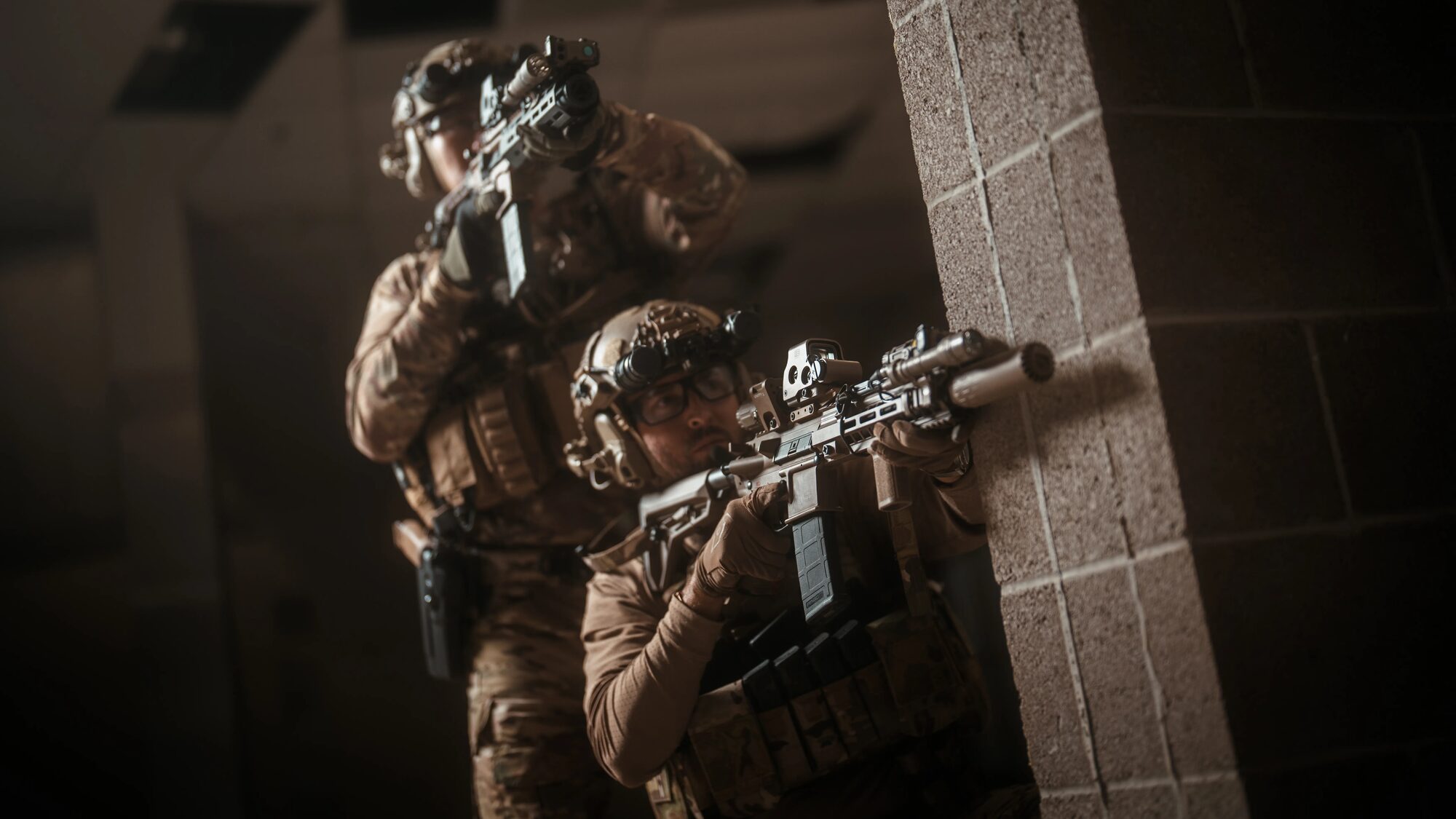 Two operators stacked at a wall at night