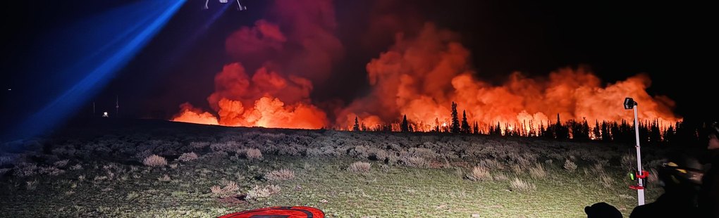 A wildland fire line burning after dark