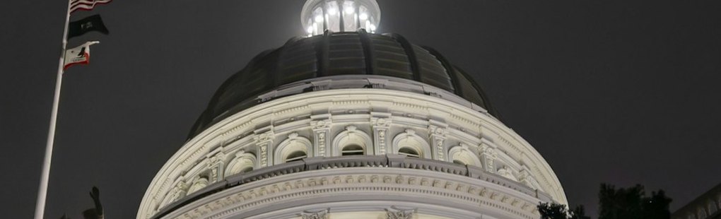 A state capitol dome lit at night