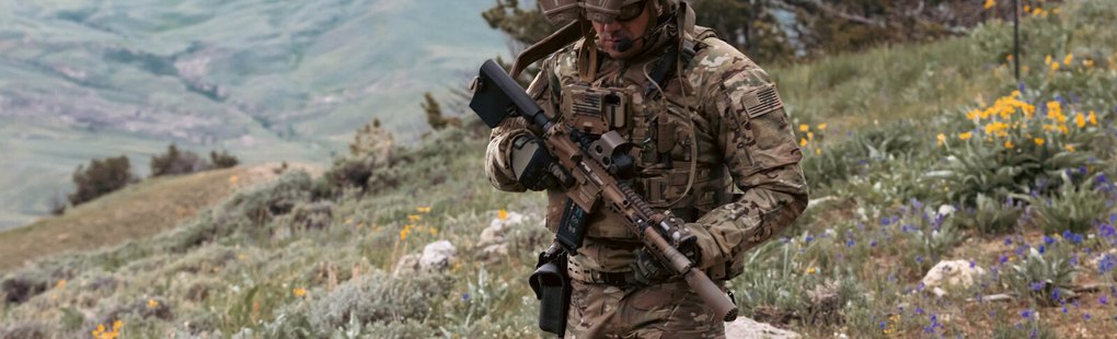 A dismounted soldier moving across open ground