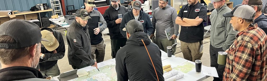 A multi-agency briefing around printed maps